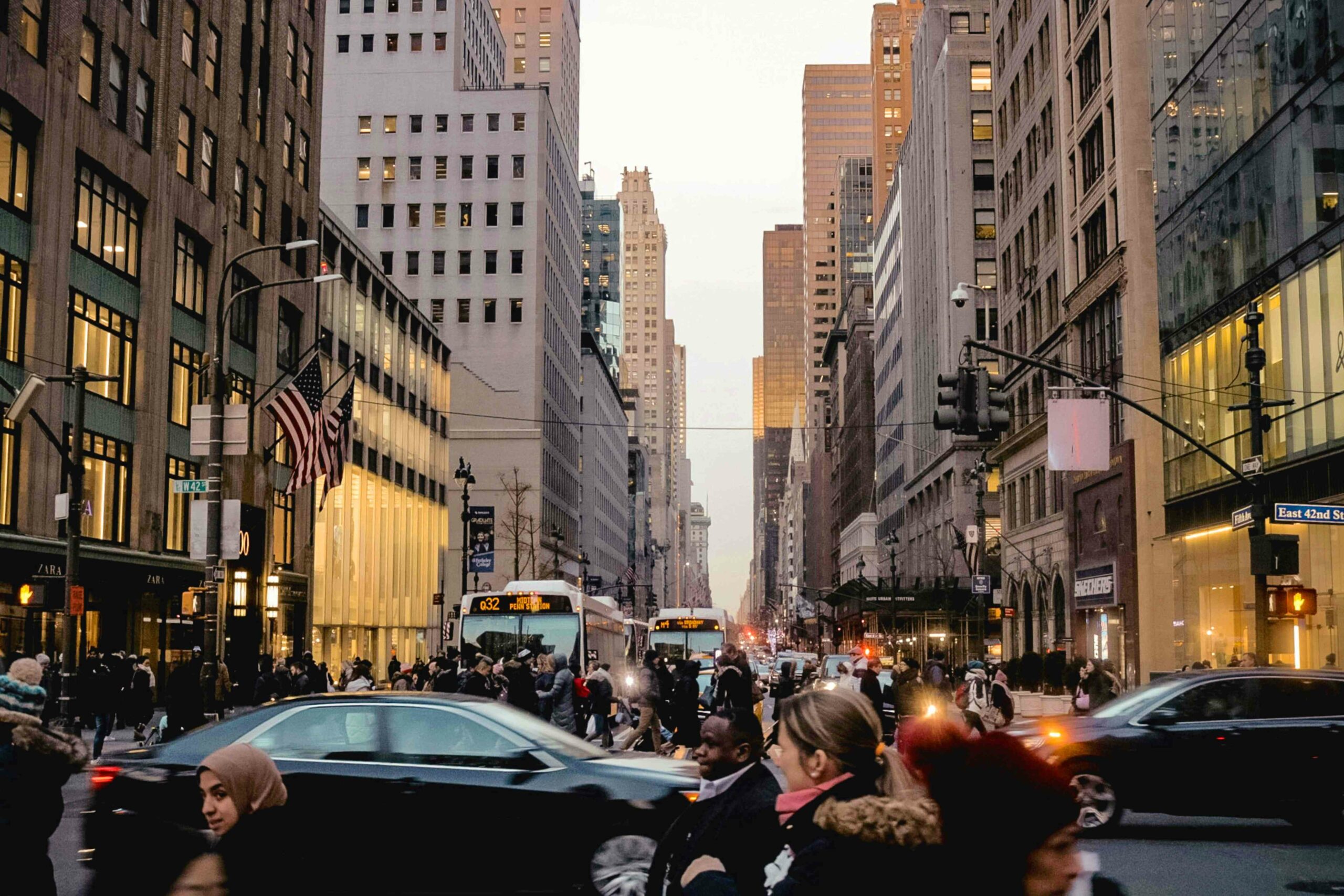 View up Fifth Avenue at 42nd Street with buses, cars and busy sidewalks